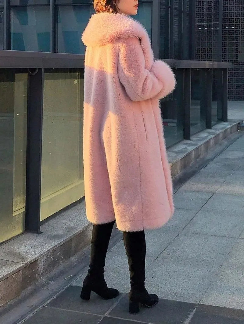 A grey women's mid-length faux fur and leather coat with a fur collar on a hanger.
