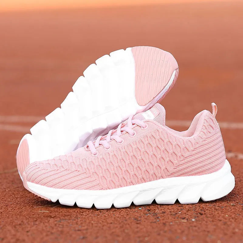 Women's running shoes in black, pink, or white with fly weaving upper and wear-resistant outsole.