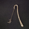 Metal bookmark with glowing five-pointed star and celestial sun moon stars design