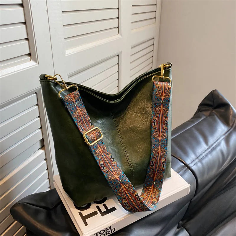 Women's large capacity crossbody bucket bag in PU with nylon lining, available in multiple colours, includes zipper change bag and phone pocket