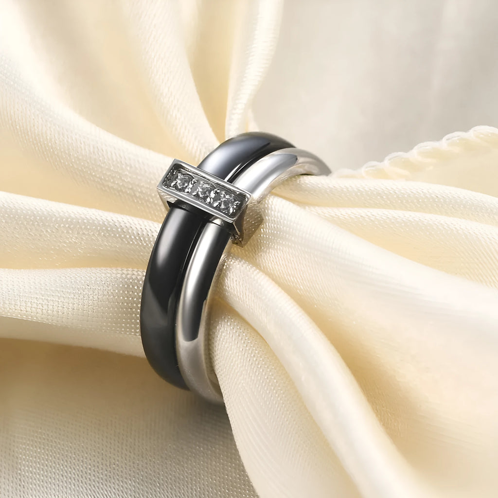 Close-up of a women's black ceramic ring with a geometric stitch pattern on a 6mm wide band, showcasing glossy finish.