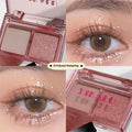 Cool two-tone eye shadow plate showing pink and black matte shimmer colours in a standard cosmetic compact.