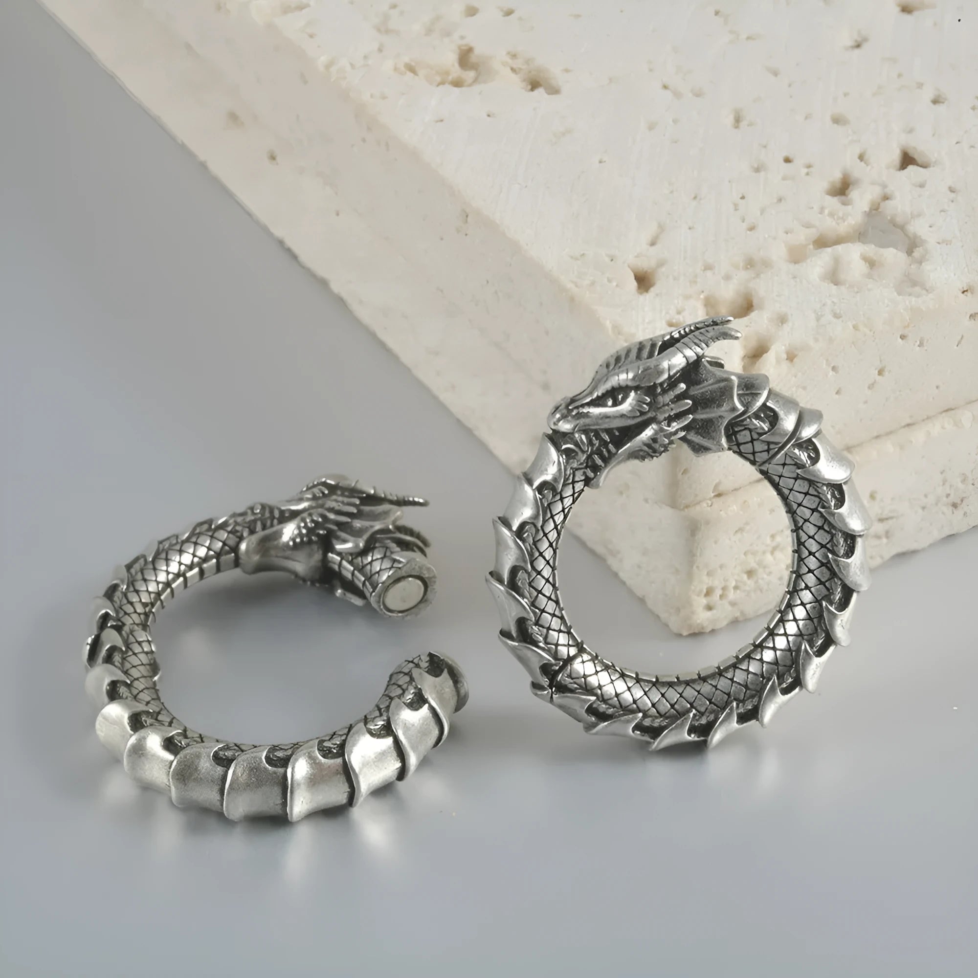 Retro geometric dragon-shaped hollow out earrings in antique silver finish, shown from the front.