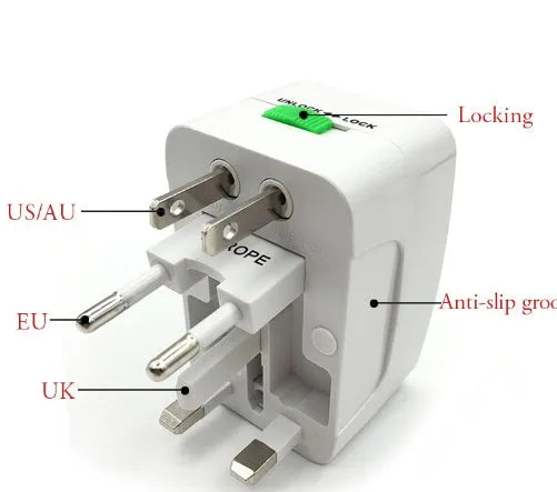 White universal travel plug adapter on a grey background showing its compact size.