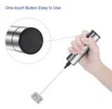 Silver electric milk frother handheld whisk with double stainless steel head on white background