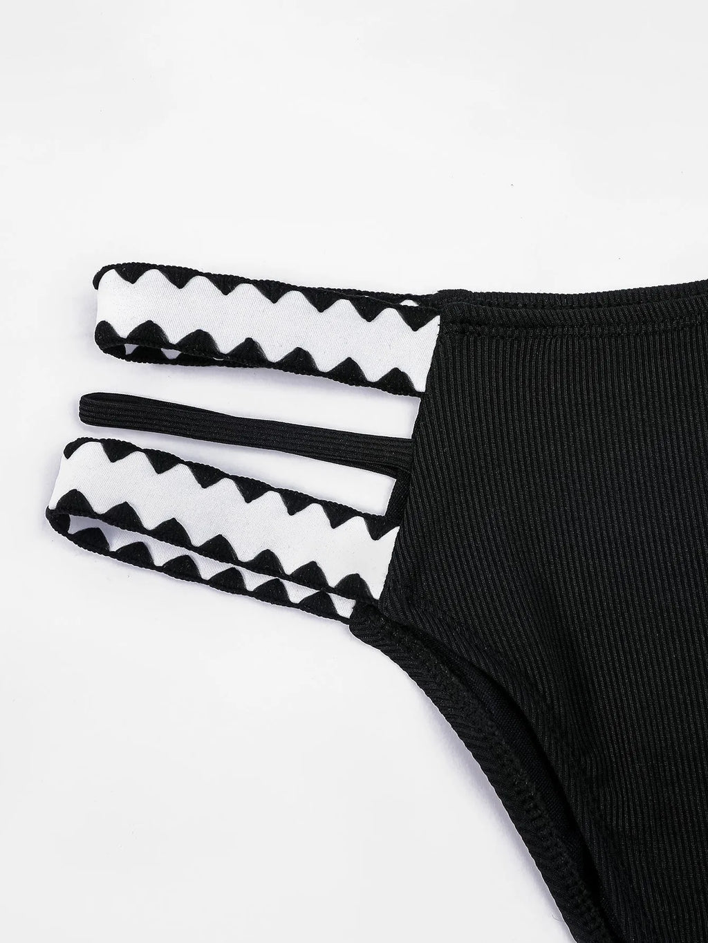 Black women's hollowed-out split swimsuit bikini on a neutral background