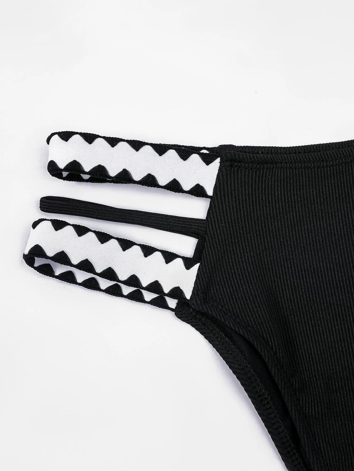 Black women's hollowed-out split swimsuit bikini on a neutral background