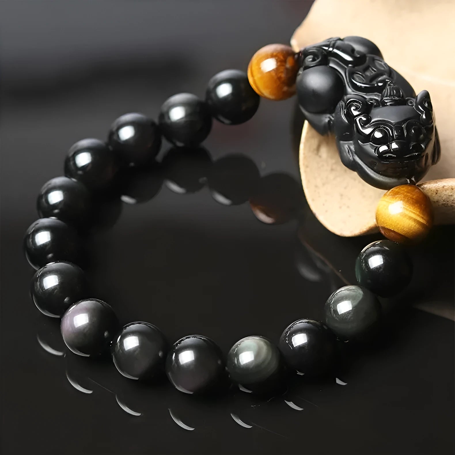 Black Mexico Gold Sheen Obsidian pi xiu bracelet with ethnic styling on wrist