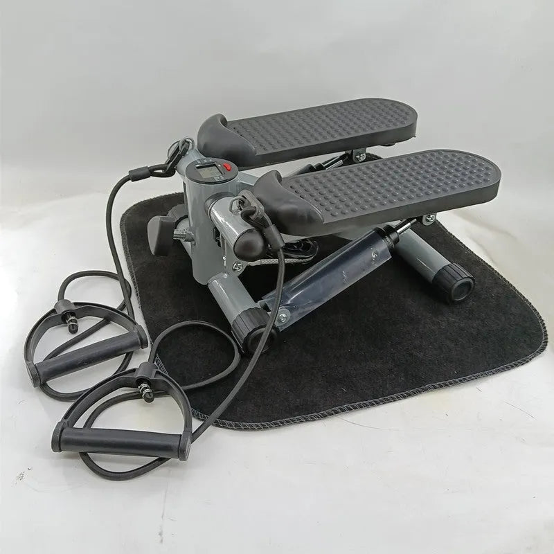 Silver grey household hydraulic pedal exercise machine for waist slimming and cardio.