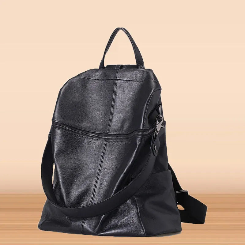 Brown genuine leather retro women's backpack with front pocket and adjustable straps.