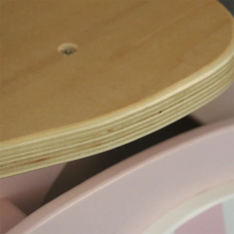 Pink wooden balance scooter for toddlers with 10-inch wheels.