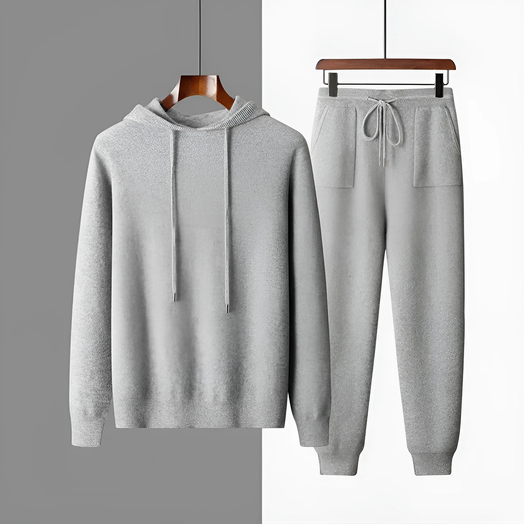 Men's light grey cashmere hooded sweatshirt and matching trousers set laid flat.