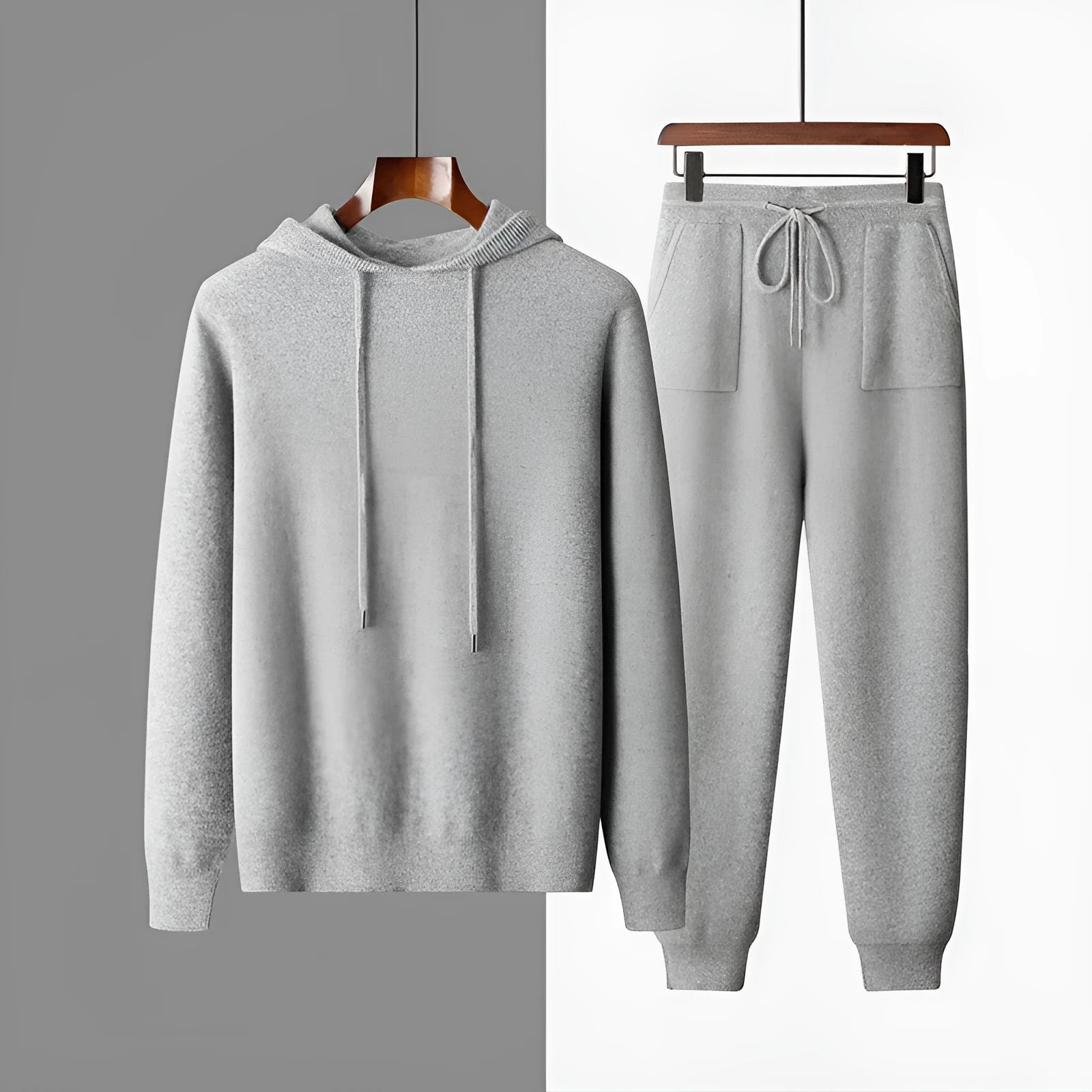 Men's light grey cashmere hooded sweatshirt and matching trousers set laid flat.