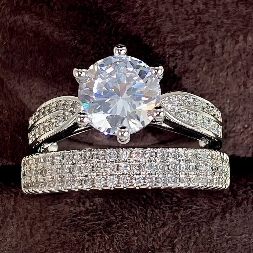 White gold alloy combined ring bracelet with round geometry design on finger.