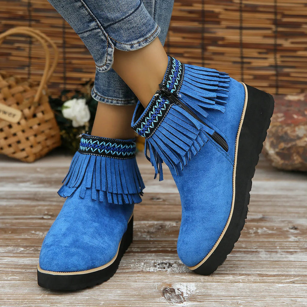 Women's dark brown suede ankle boots with a wedge heel, thick platform sole, tassel detail, and side zipper.