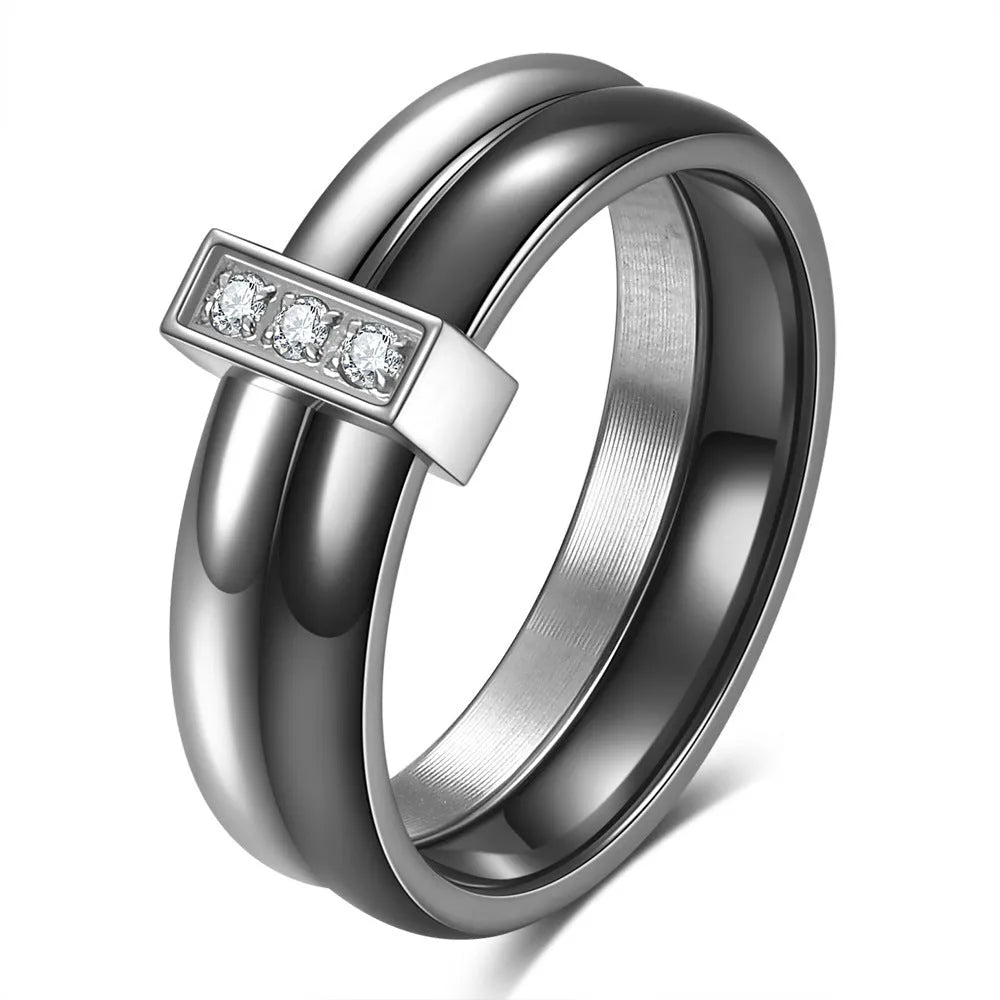 Close-up of a women's black ceramic ring with a geometric stitch pattern on a 6mm wide band, showcasing glossy finish.