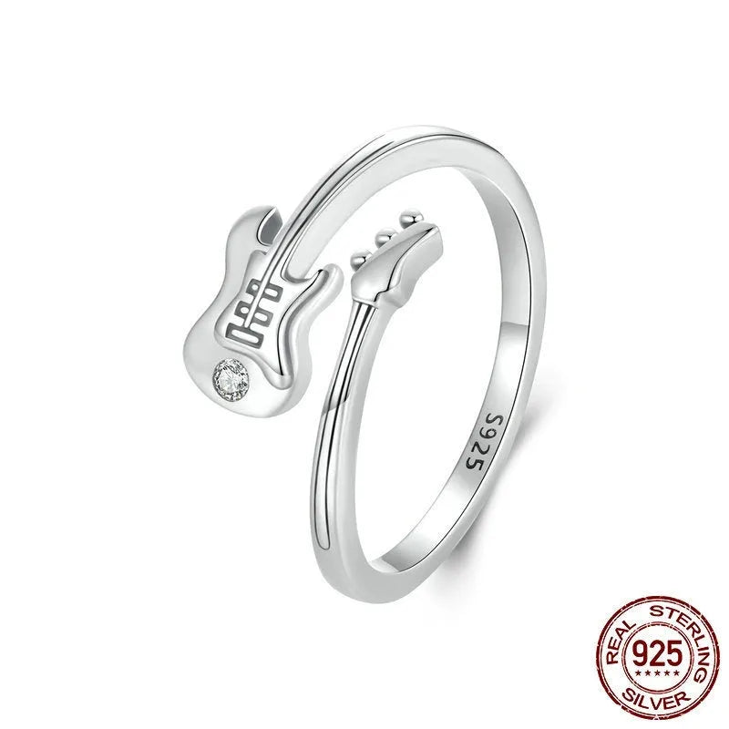 S925 silver oxidised open ring with guitar ornament on neutral background
