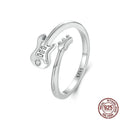 S925 silver oxidised open ring with guitar ornament on neutral background