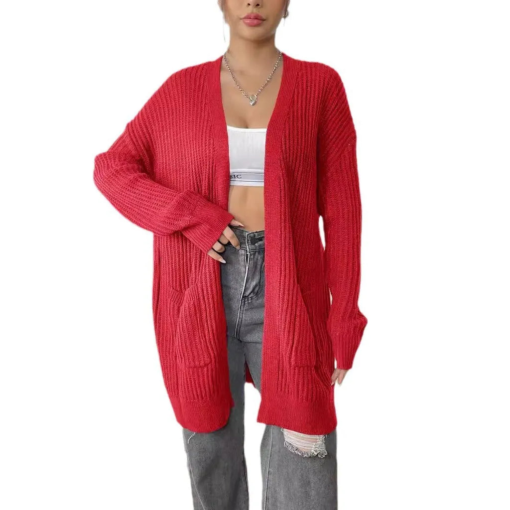 Women's dark green loose cardigan with two front pockets and long sleeves.