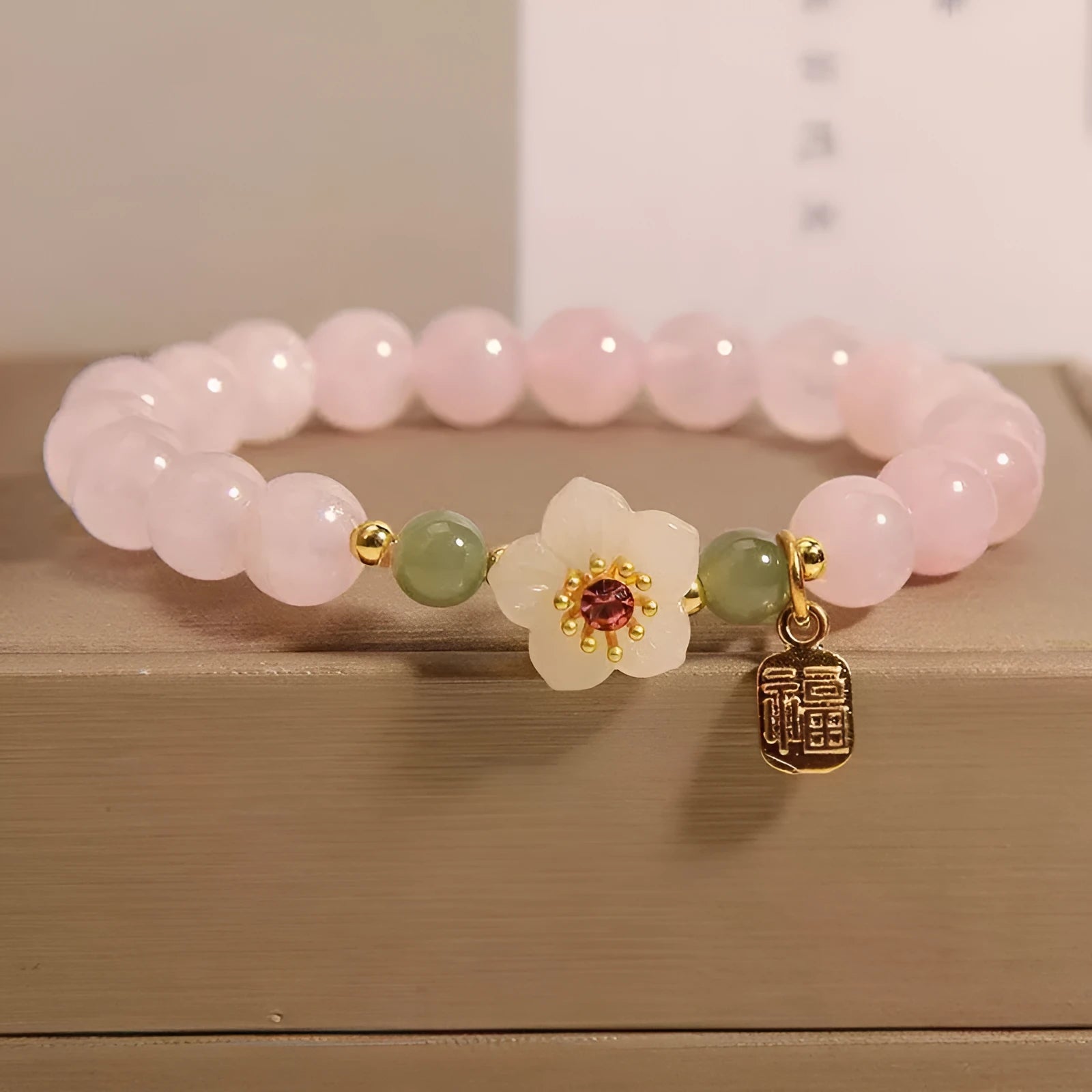 Crystal Hetian jade bracelet with peach blossom beads and camellia floral elements in pastoral national style design