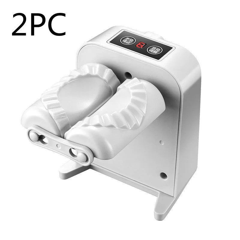 White automatic electric dumpling maker machine with USB charging cable, brush, and spoon on a kitchen counter.