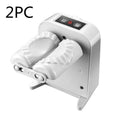 White automatic electric dumpling maker machine with USB charging cable, brush, and spoon on a kitchen counter.