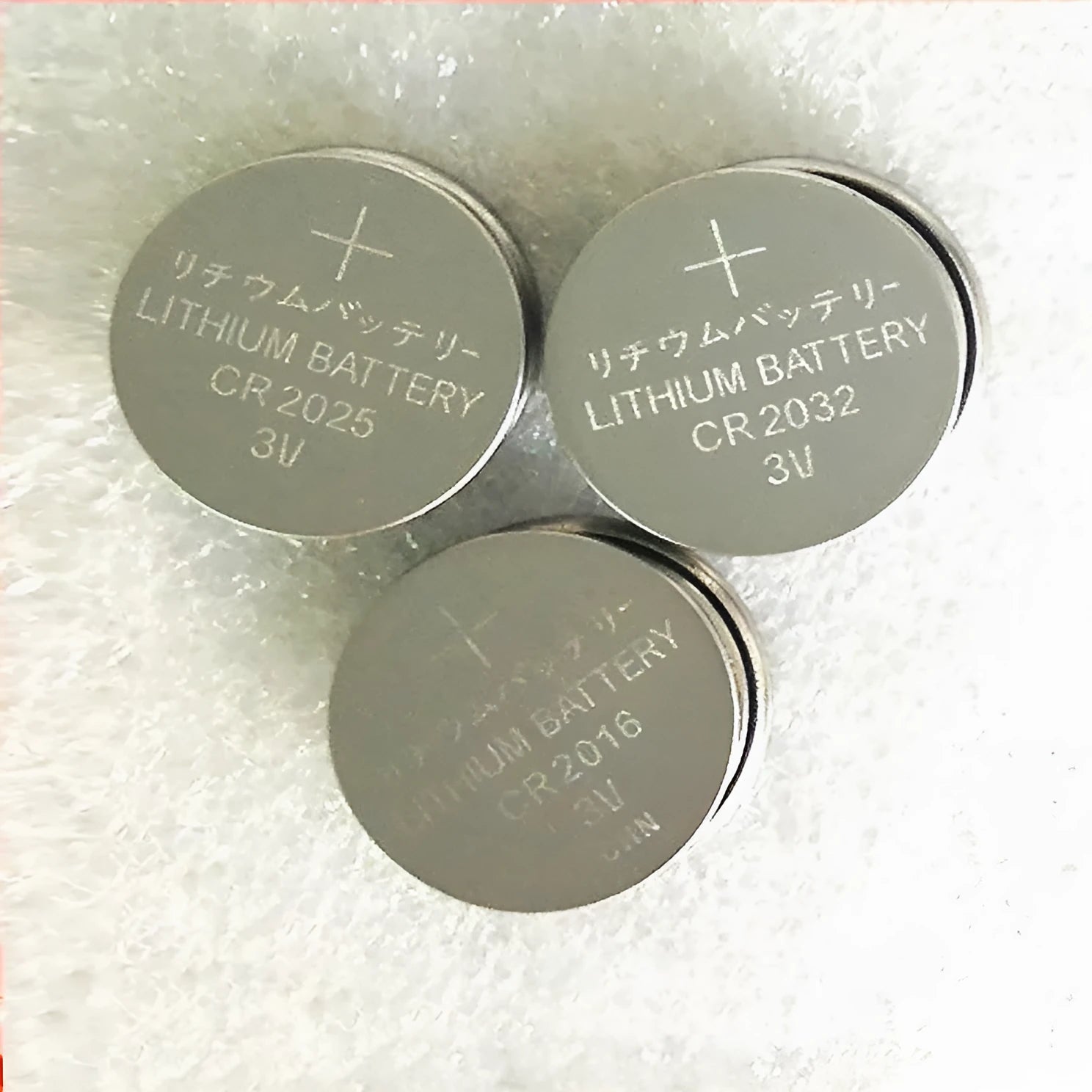 Pack of 3V alkaline button batteries showing CR2032, CR2025, and CR2016 coin cells for small electronics.