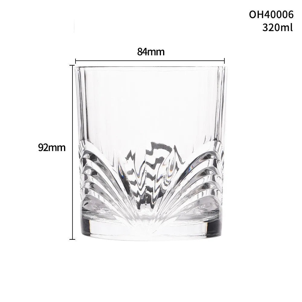 Thick-bottomed clear crystal whiskey shot glass on a table.