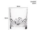 Thick-bottomed clear crystal whiskey shot glass on a table.