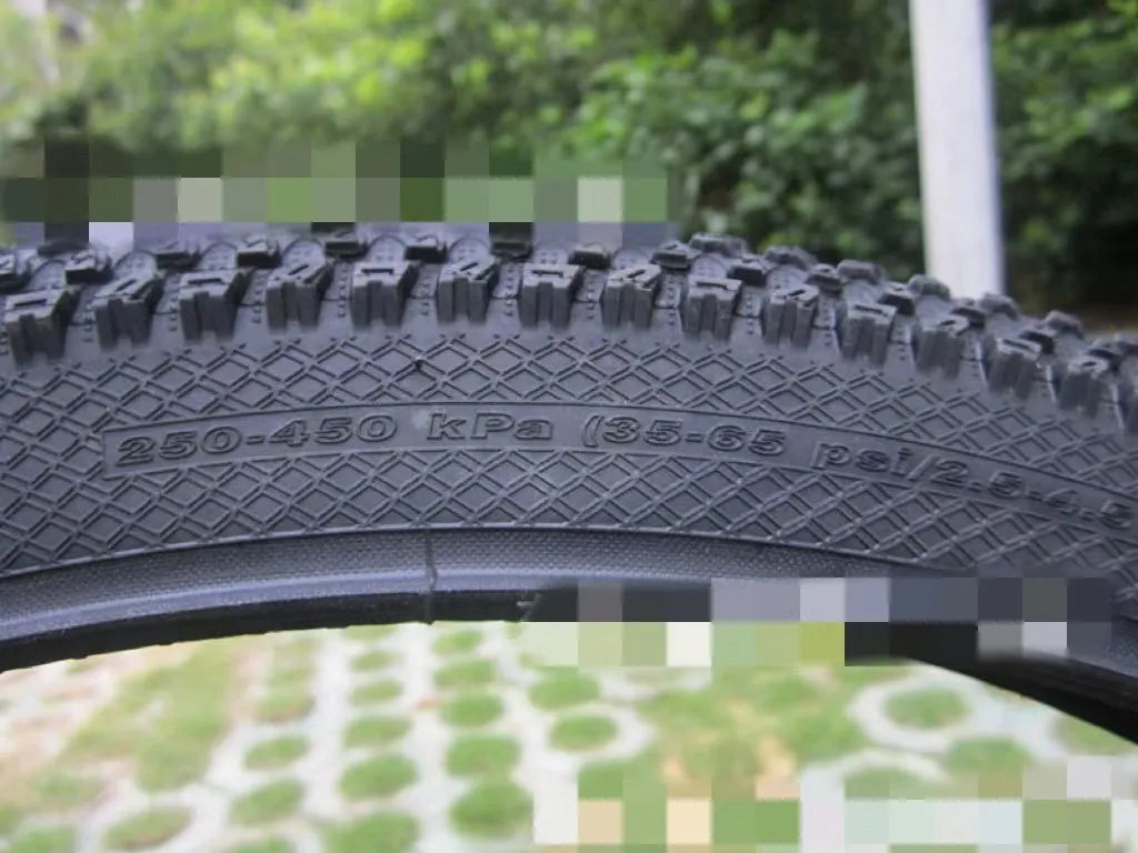 Ultralight mountain bike tyre with black tread and optional white sidewall, shown in sizes 26, 27.5 and 29 inch.