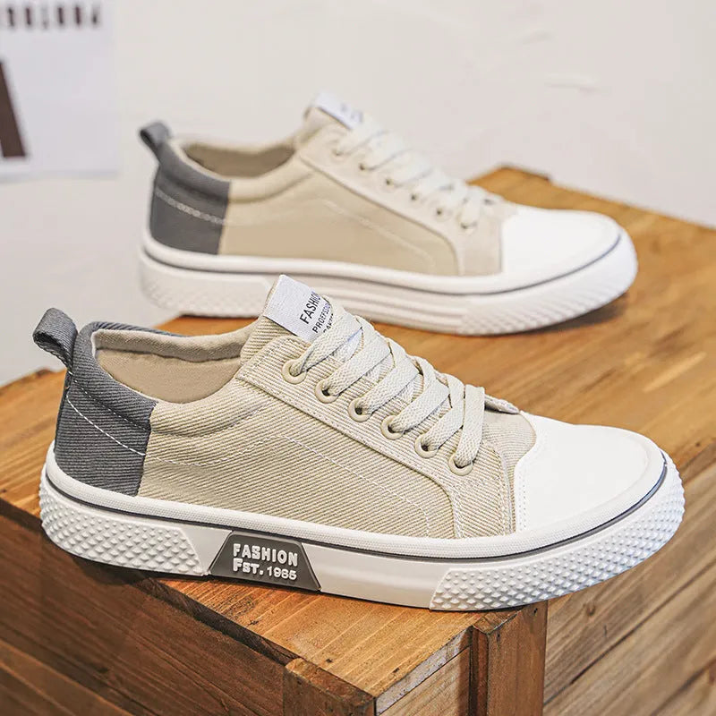 Men's blue low-top canvas casual sneakers with round toe and lace-up front on a white background.