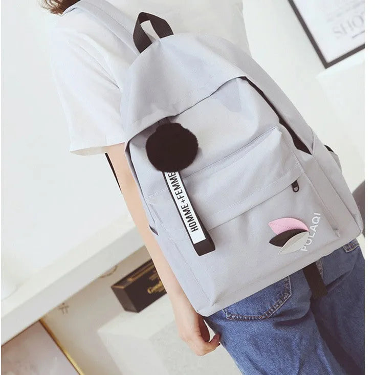 Green canvas college style schoolbag with leaves pattern and anti-theft features