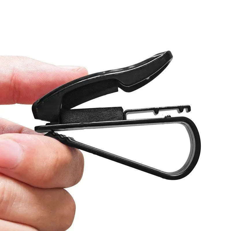 Black plastic car sunshade clip for holding glasses and cards, measuring 6.5 by 2.3 centimetres.