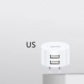 White portable universal dual USB phone charger with US EU UK plug compatibility and 39mm diameter