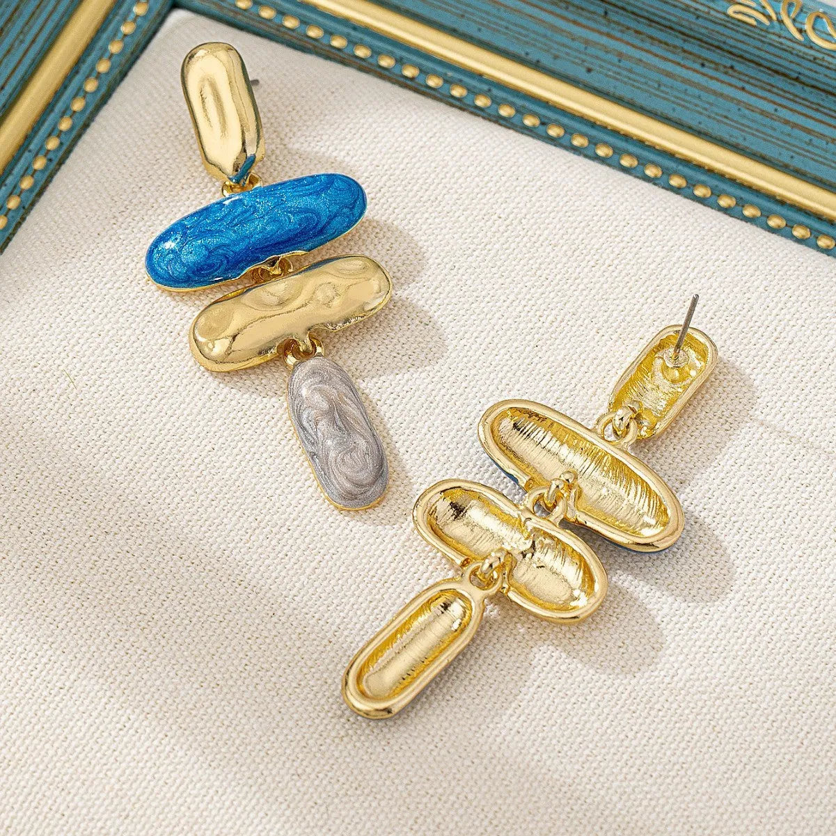 A pair of women's geometric stud earrings with a multicolour electroplated finish on zinc alloy.