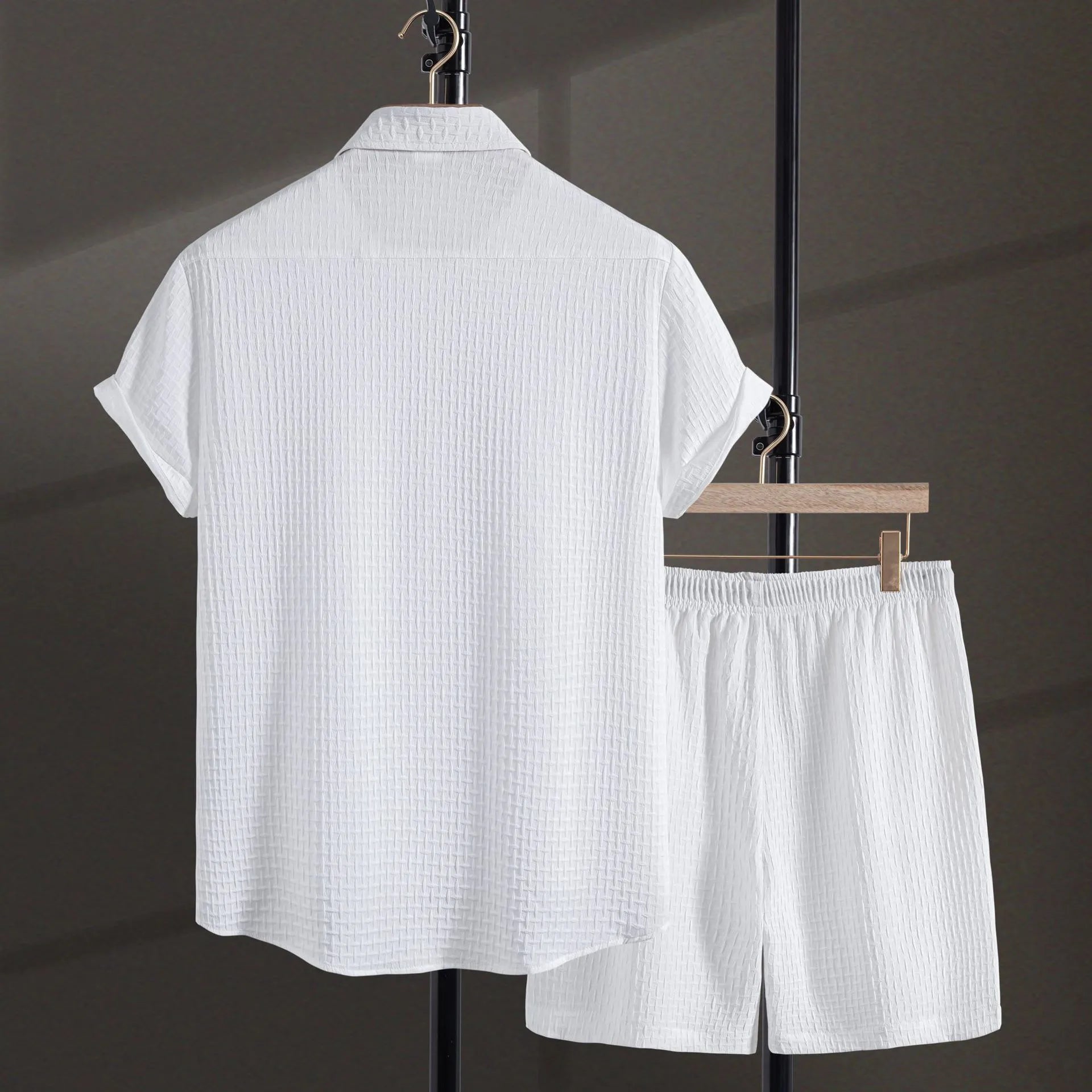 Men's white cotton blend beach shorts suit with short sleeve shirt on a hanger.