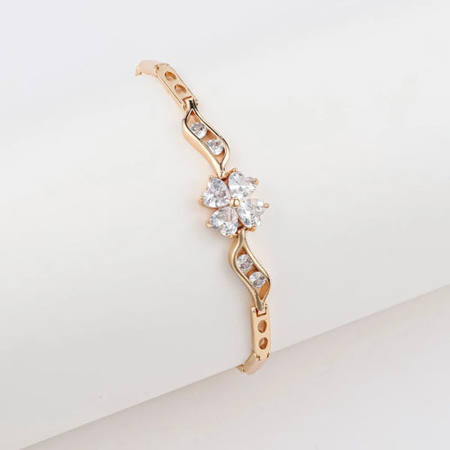 18K gold-plated butterfly clover brass bracelet with zircon stone on plain background