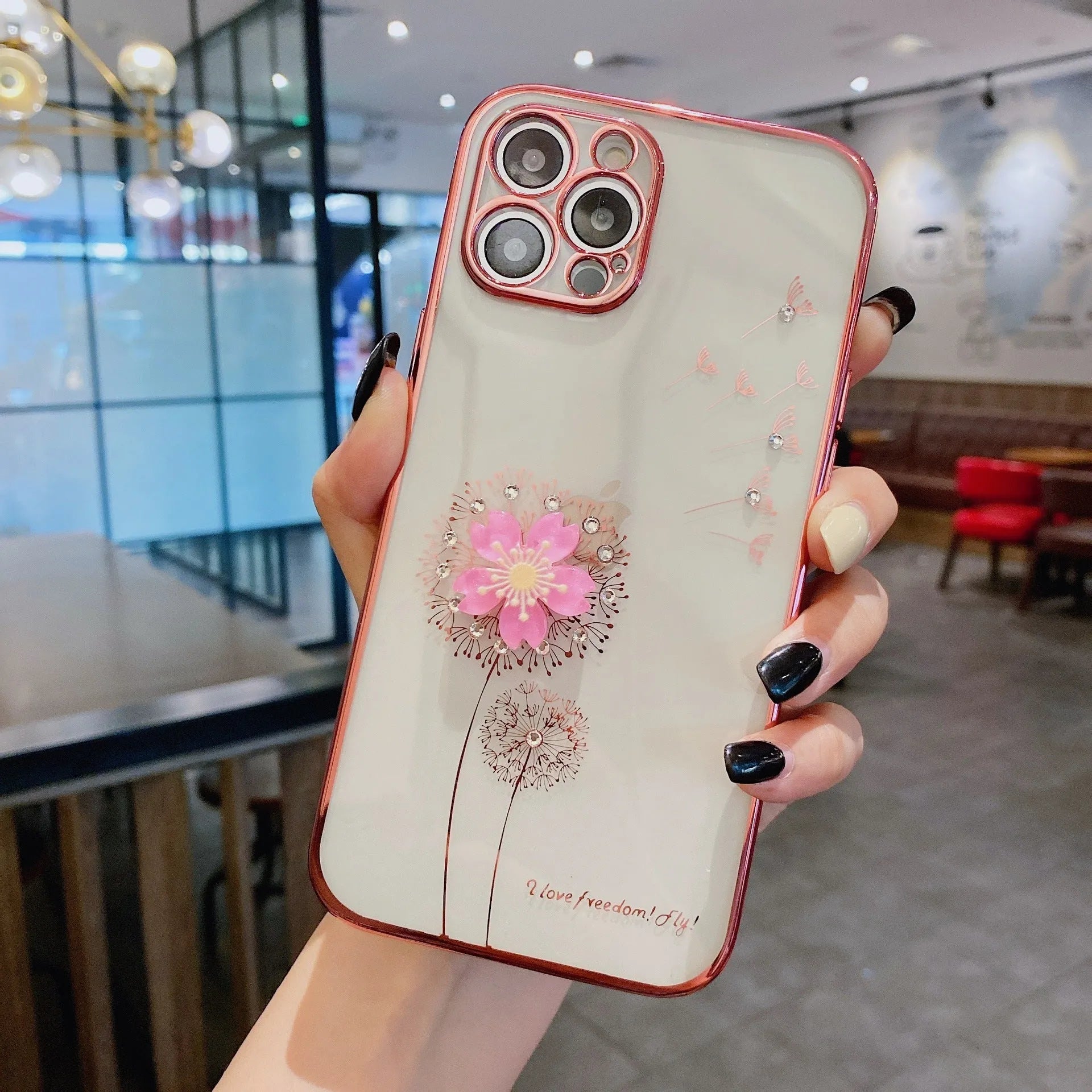 Green iPhone case with 3D white floral design and a silver rotating kickstand extended at the back.