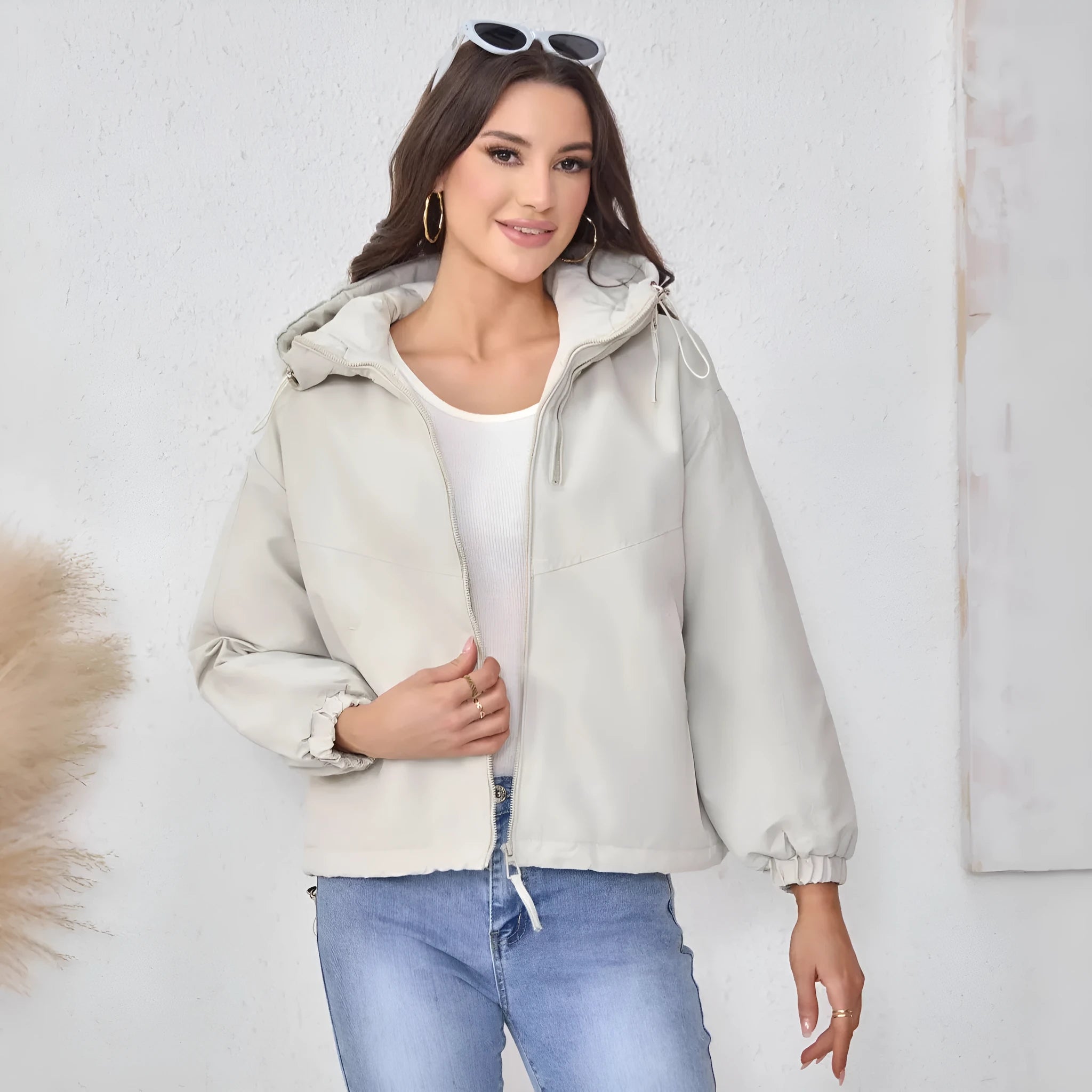 Women's grey loose-fit hooded polyester jacket with full zip and long sleeves.
