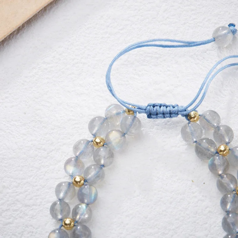 Grey moonstone woven bracelet with butterfly pattern and silver tone clasp