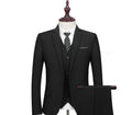 New men's slim fit black business suit set with 1-button jacket, waistcoat, shirt, and trousers on a hanger.
