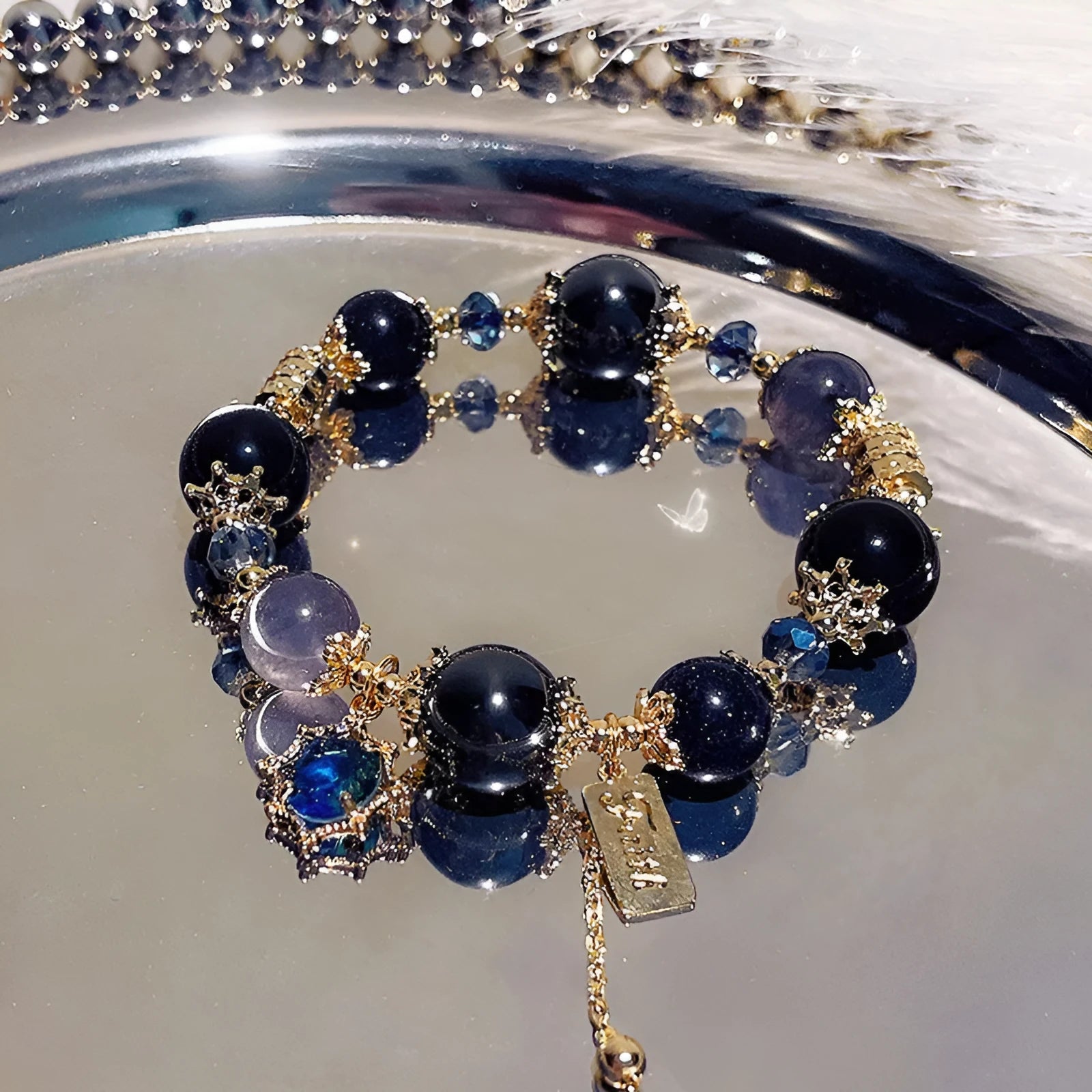 Women's bracelet with snowflake pendant and bow charm in galaxy colour