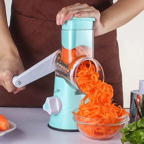 Blue round manual mandoline slicer with stainless steel blade for vegetables on a kitchen counter.