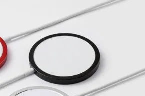 Silver anodised aluminium Magsafe-compatible wireless charger disc for iPhone