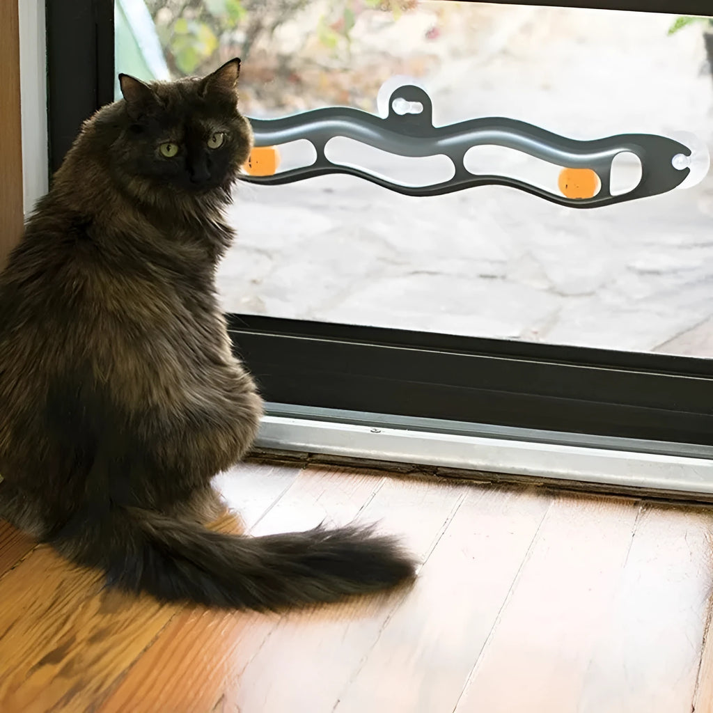 Grey plastic cat climbing frame with track ball toy on a windowsill, approximately 57cm long and 10cm wide