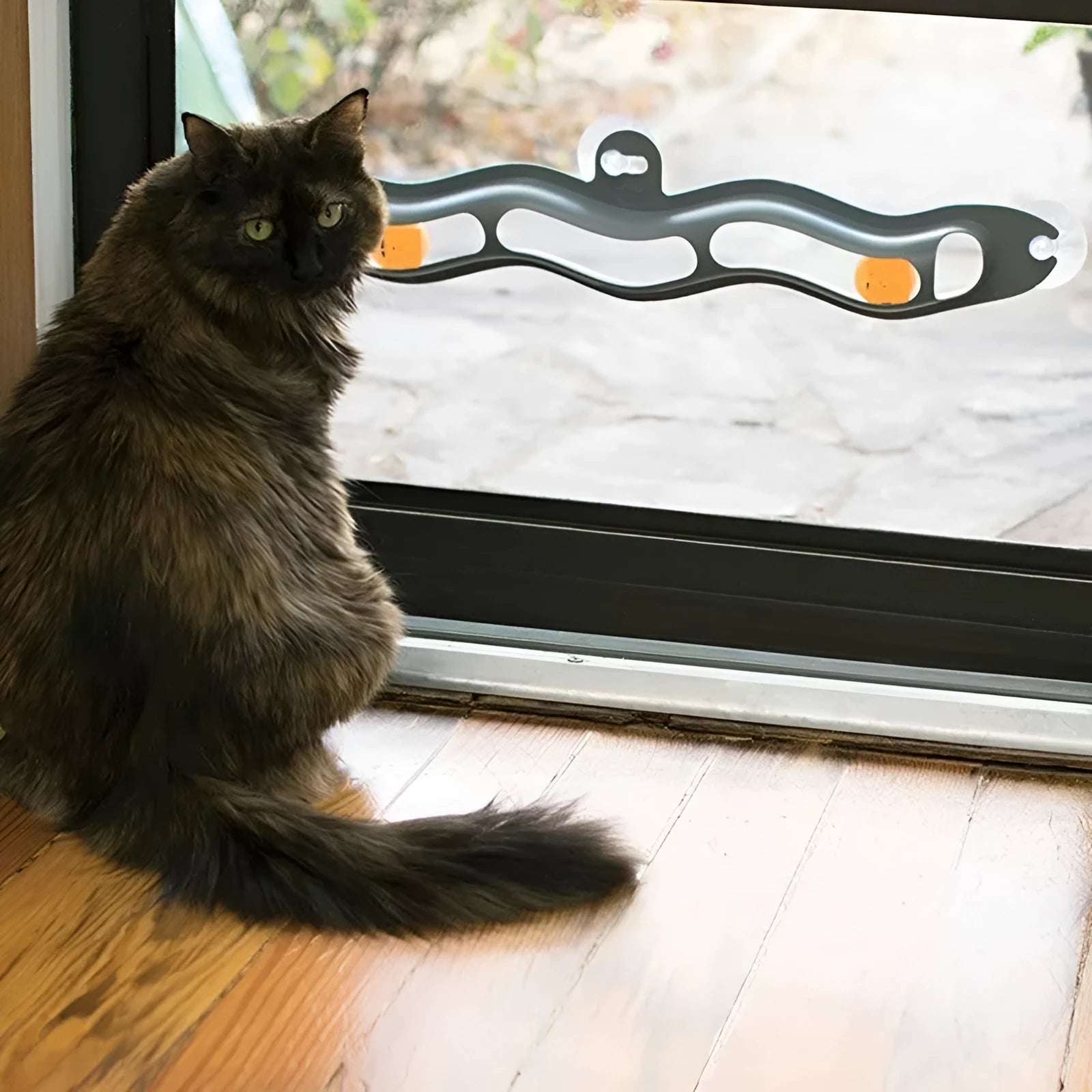 Grey plastic cat climbing frame with track ball toy on a windowsill, approximately 57cm long and 10cm wide