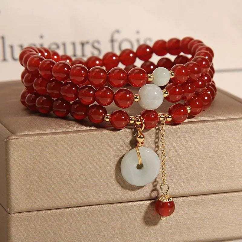 Red agate multi-layer crystal bracelet with a retro ethnic style on a white background.