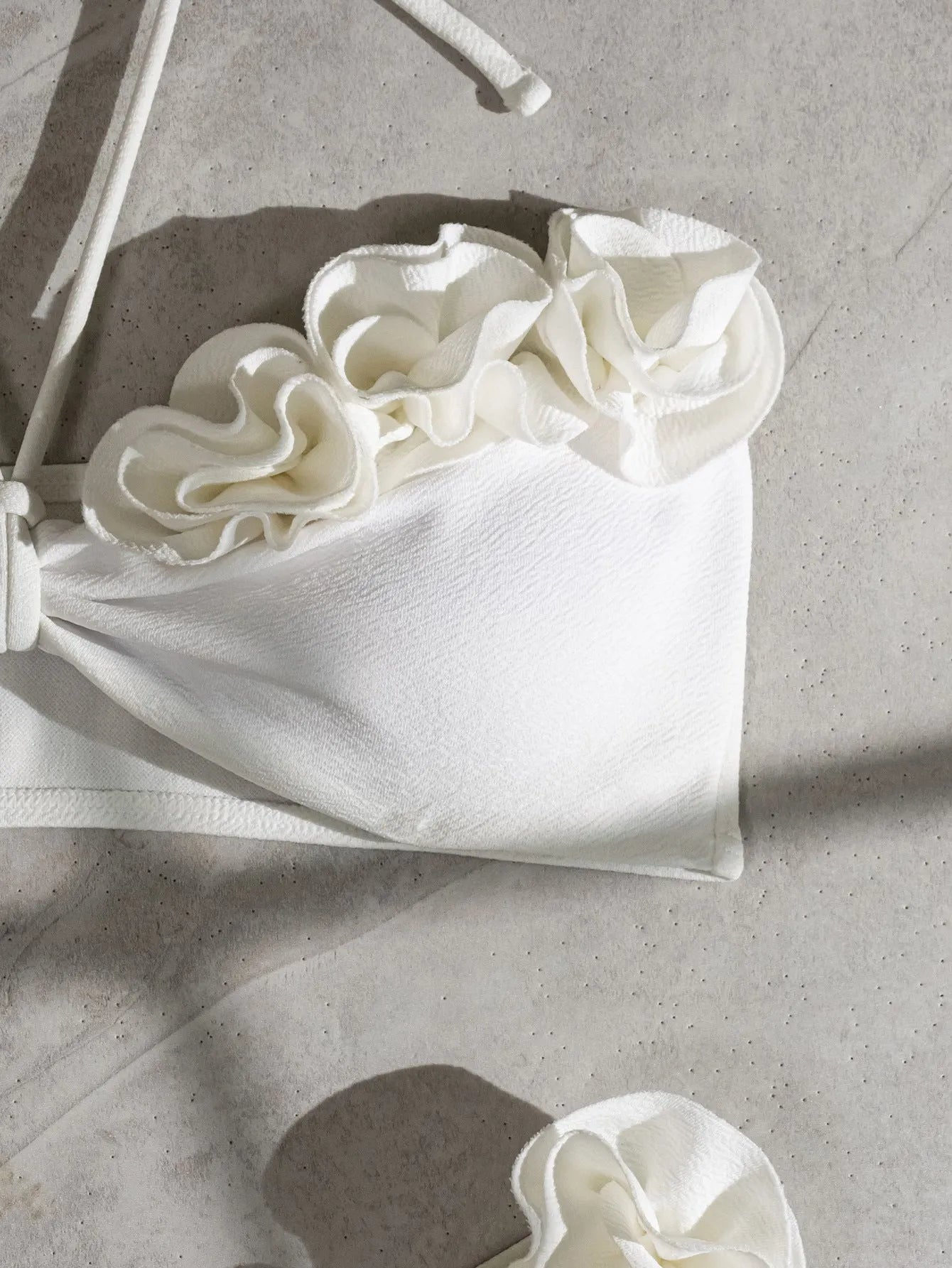 White halter neck lace-up swimsuit bikini with three-dimensional flower pattern.