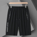 Man wearing black quick-dry nylon sports shorts with a loose fit and elastic waistband.
