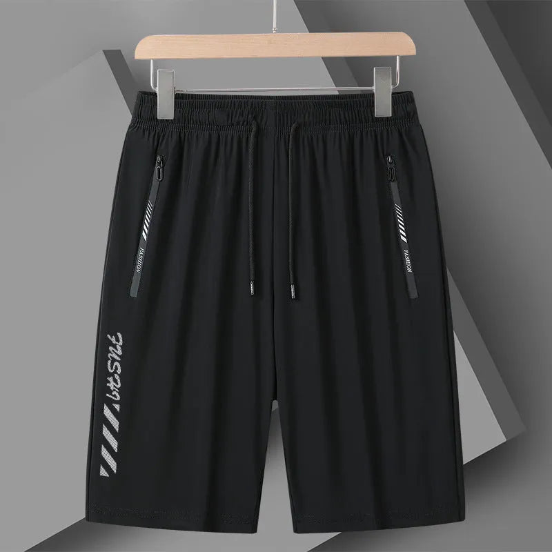 Man wearing black quick-dry nylon sports shorts with a loose fit and elastic waistband.
